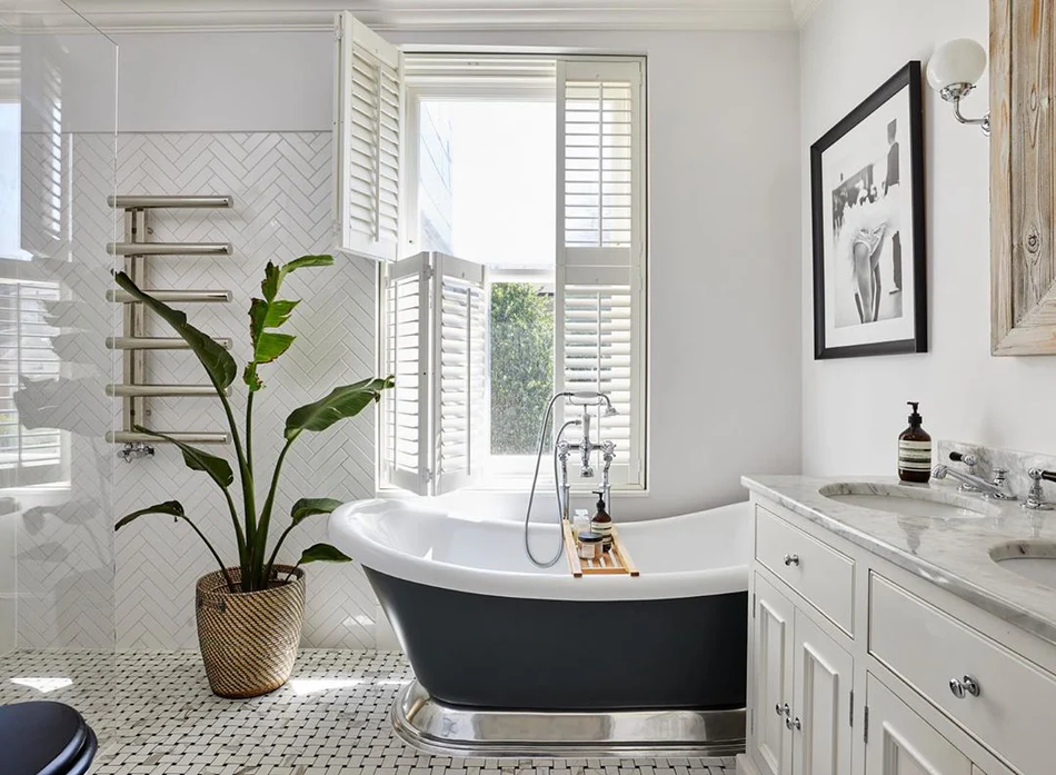 Bright bathroom with custom white plantation shutters filtering natural light
